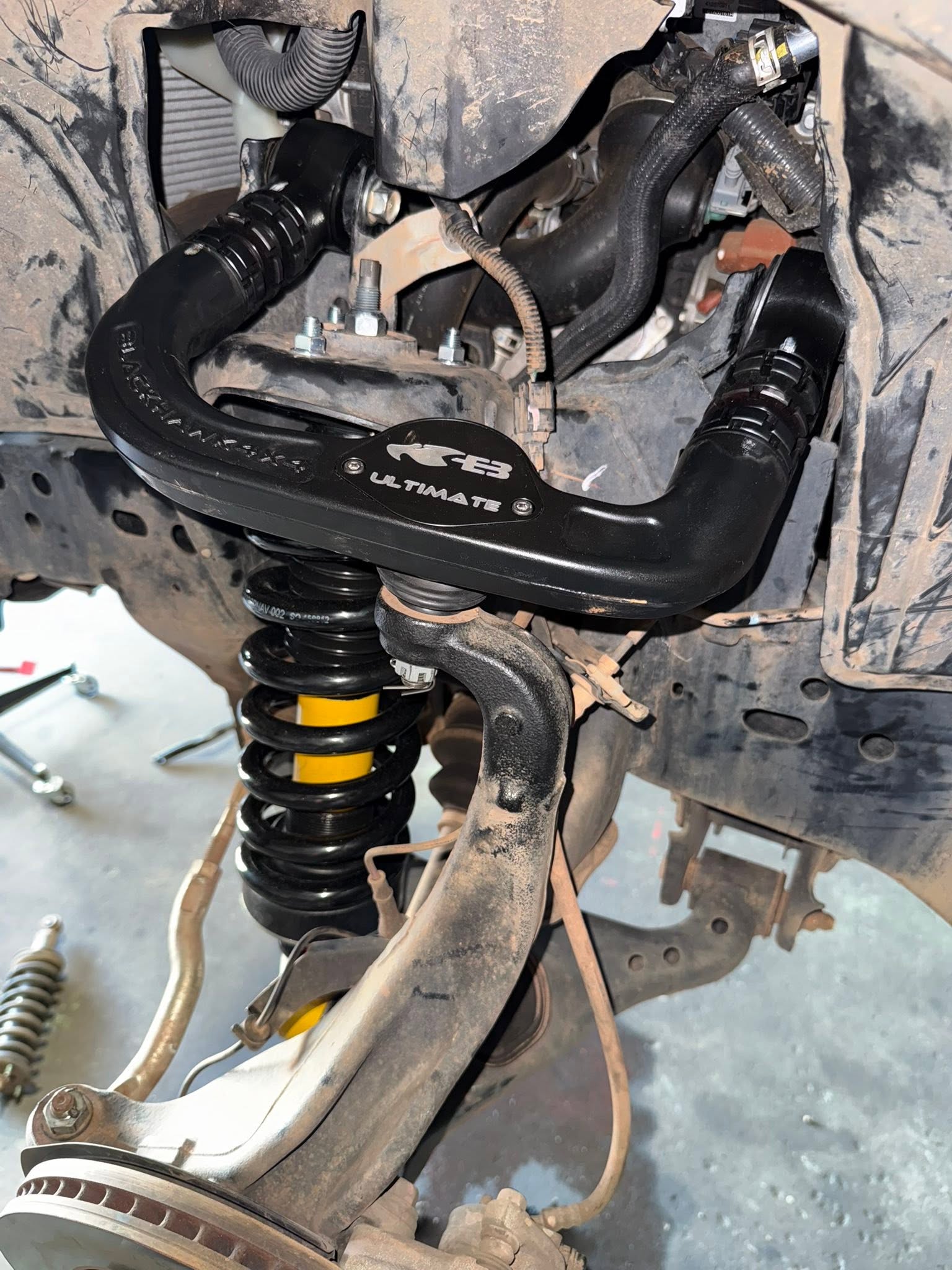 Aftermarket coilover suspension assembly during 4x4 installation in Darwin