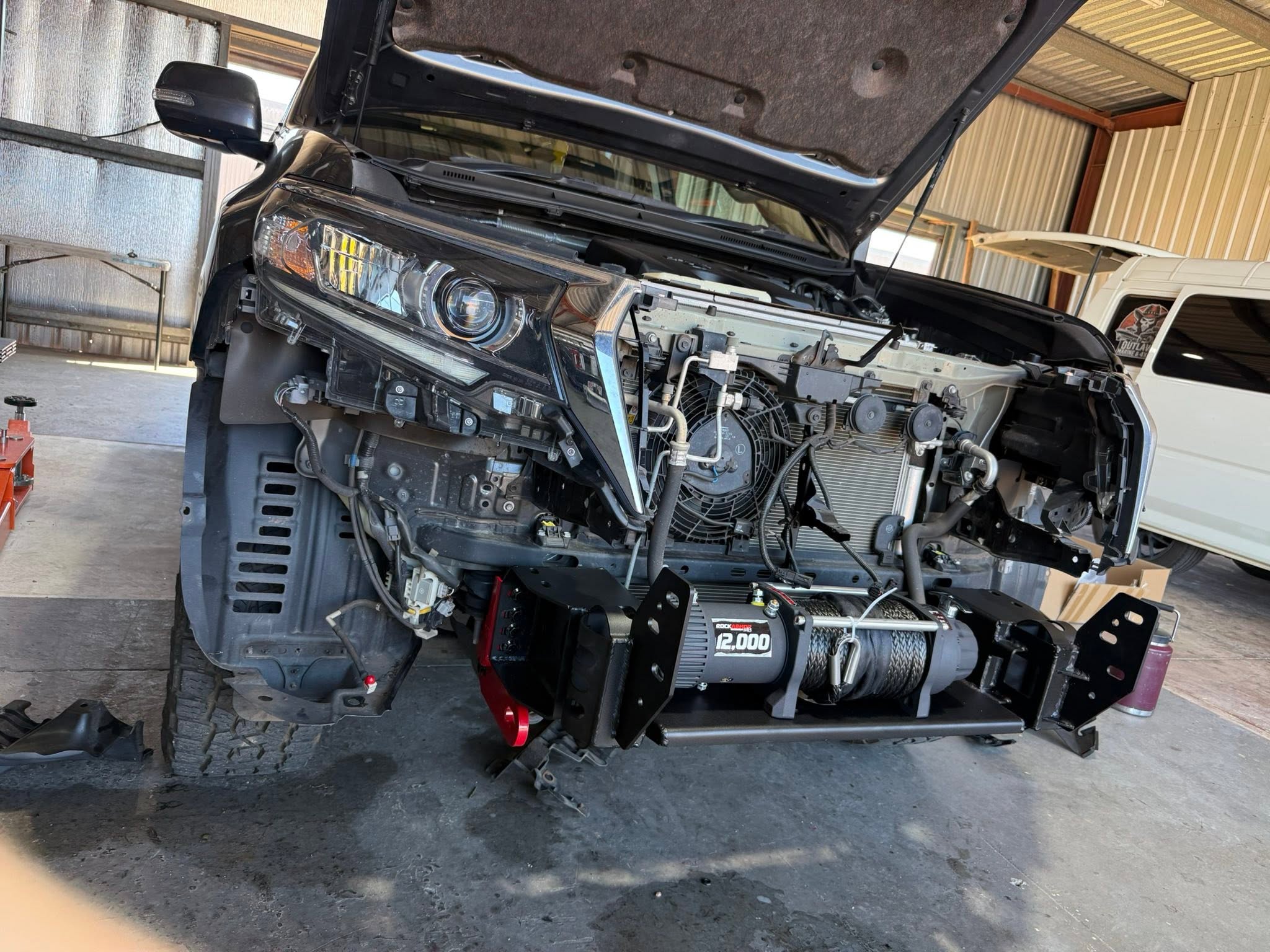 Mechanic carrying out repairs on a 4WD before a tow bar and bull bar fitting at Outlaw Marine and 4x4 Darwin