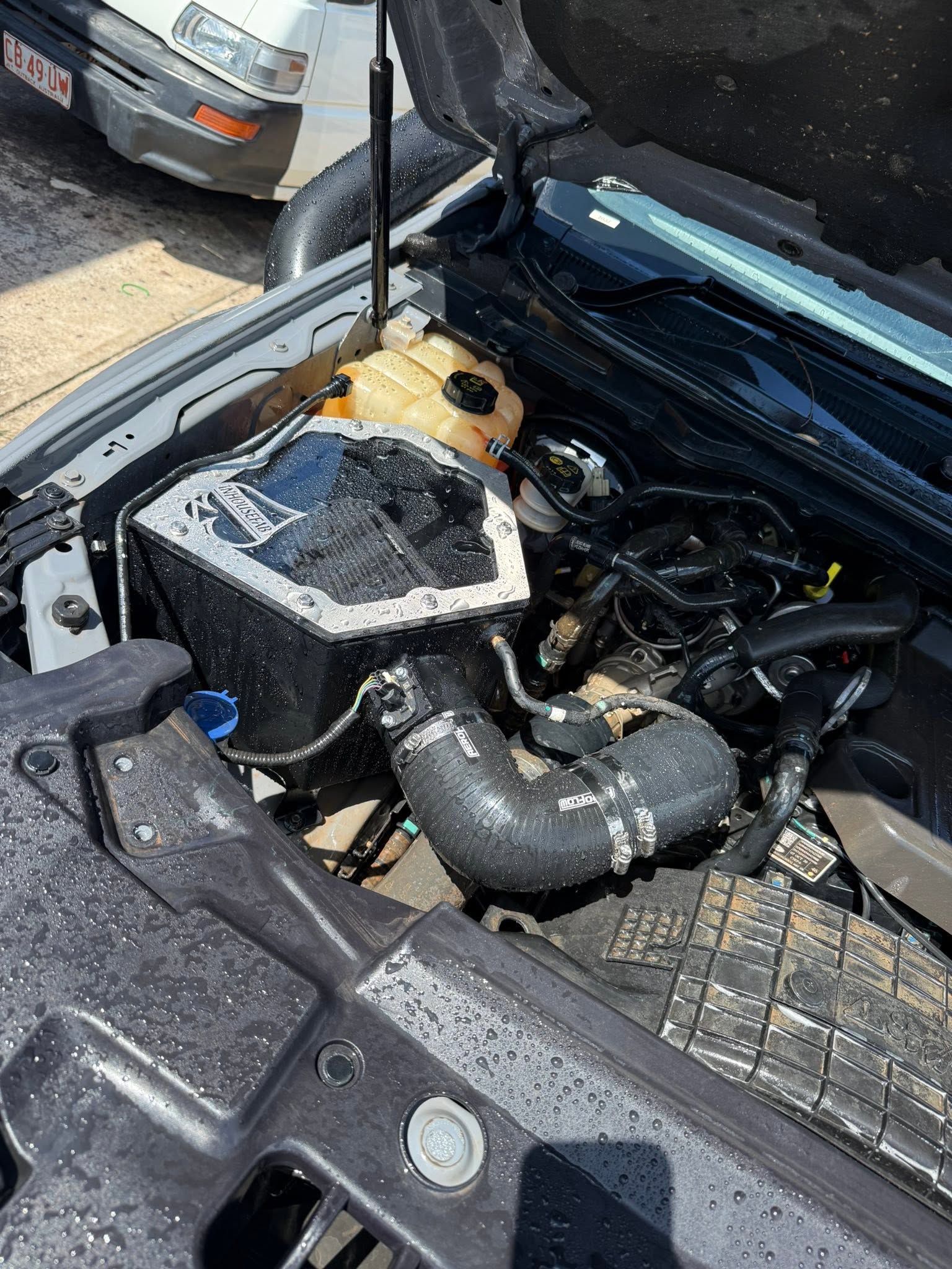 Mechanic inspecting an engine during auto repairs at the Outlaw Marine and 4x4 workshop