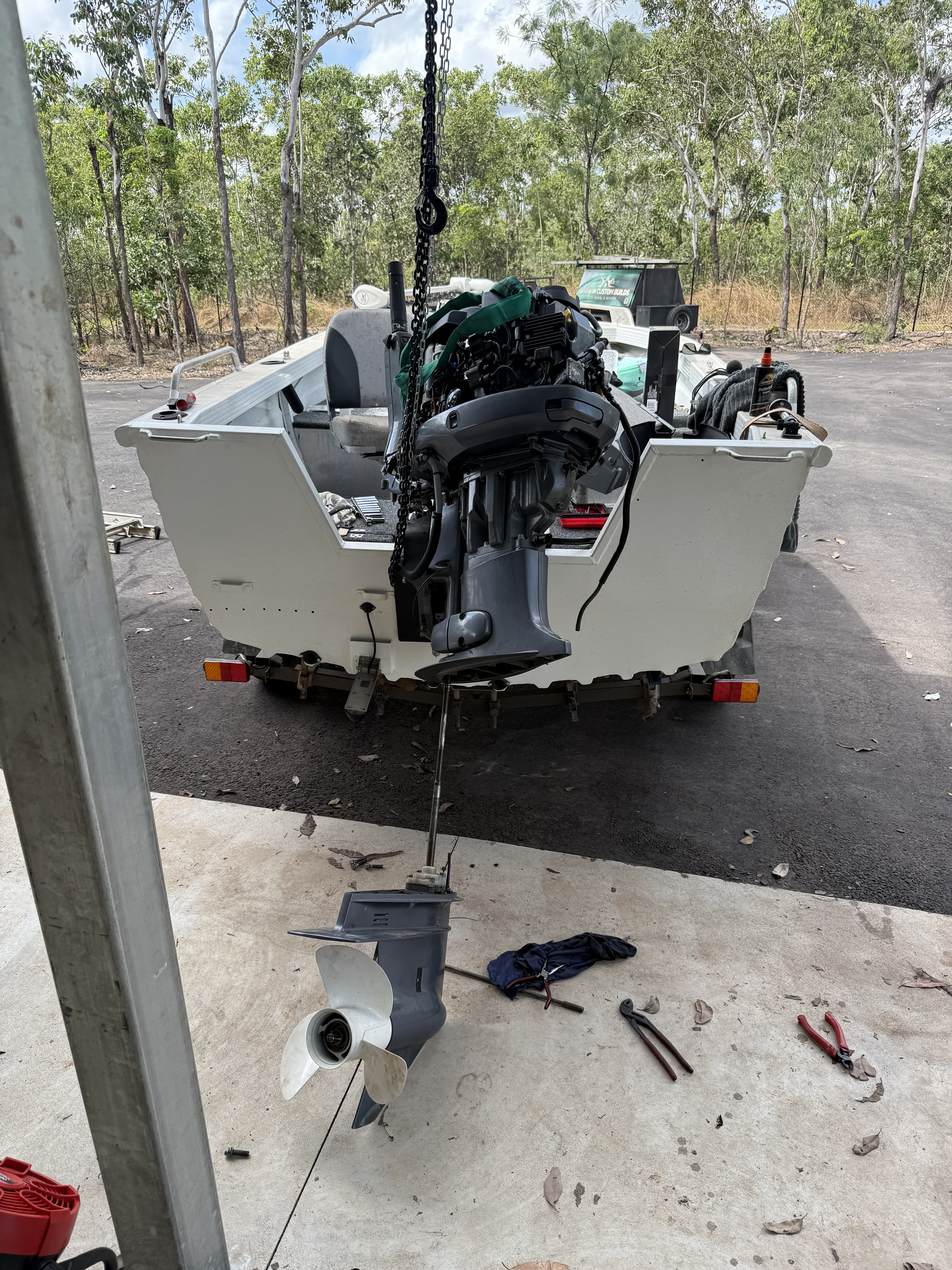 Close-up of an outboard motor component during marine repairs in Darwin